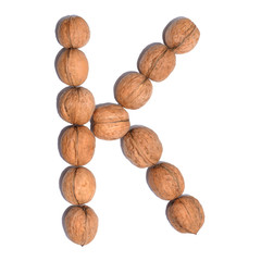 Letter K made with nuts to form a letter of the alphabet. Fruit letters on a white background.