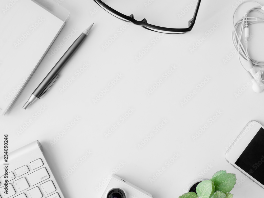 Poster top view of office desk work space with notebook, smartphone and gadget on white background with cop