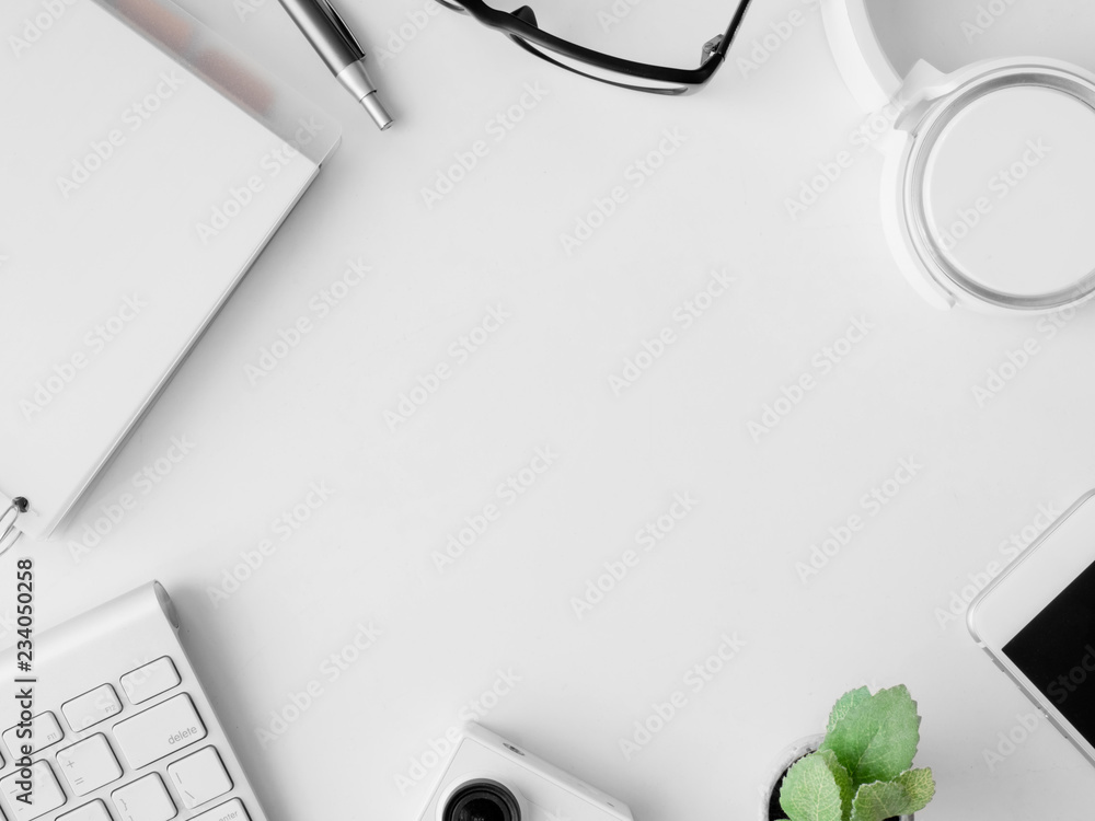 Poster top view of office desk work space with notebook, smartphone and gadget on white background with cop
