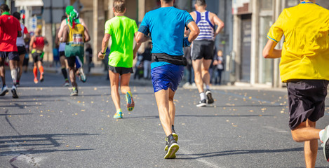 Marathon running race, runners running on city roads