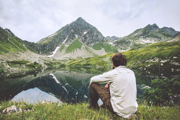 Fototapeta premium Man enjoying landscape traveling alone adventure vacations solitude lifestyle outdoor silence lake and mountains reflection landscape