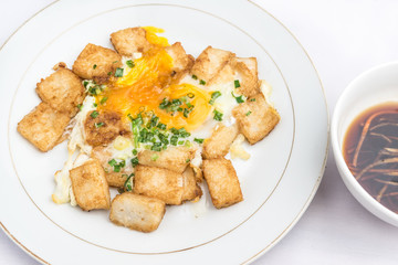 Banh bot chien - Vietnamese cuisine: a Vietnamese street-food of crispy and chewy rice cakes surrounded by an omelet-style amount of eggs, green onions.  It is a Chinese-influence pastry.