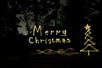 write christmas greetings with golden lights at night