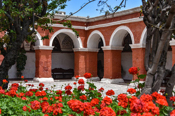 Fototapeta na wymiar Arequipa, Peru - October 7, 2018: Colorful archways and floral gardens in the Santa Catalina Monastery