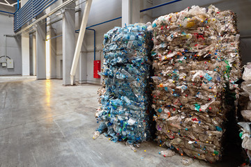 Compressed bales of polyethylene used PET bottles from drinks sorted and packaged for further...