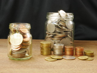 concept saving money,coins in a jar