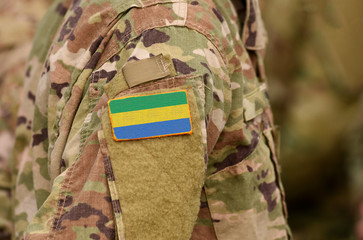 Gabonese Republic flag on soldiers arm. Gabon troops (collage)
