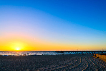 Glenelg beach with people at sunset