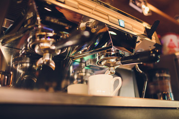 Obraz na płótnie Canvas Professional coffee machine making espresso in a cafe.
