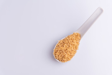 Raw Brown Rice on white background. Integral Wholegrain. Latin term Oryza sativa also known as Whole Chinese Rice seed