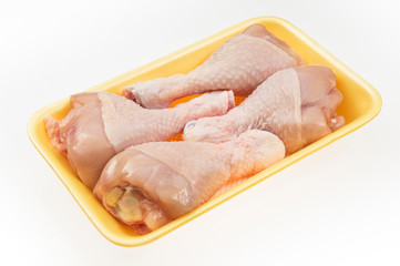 Fototapeta na wymiar Fresh chicken drumsticks with skins in package