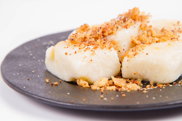 Dumplings with cottage cheese (traditional polish dish called lazy pierogi/ leniwe pierogi) fried with bread crumbs and sprinkled with sugar