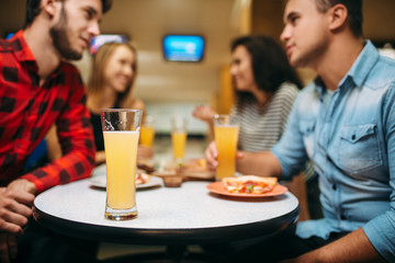 Friends in bowling club, game board on background