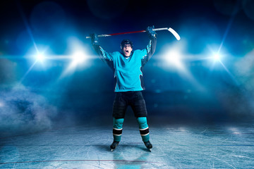 Hockey player raised his hands up, winner