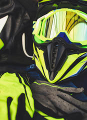 Cross helmet, gloves yellow fluorescent. Equipment for motorcycles. Enduro on the trip.
