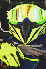 Cross helmet, gloves yellow fluorescent. Equipment for motorcycles. Enduro on the trip.