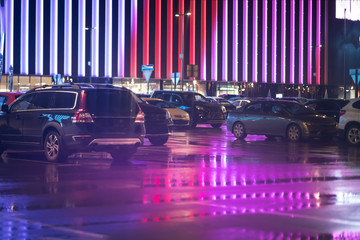 night lights reflected in a parked car © Mak