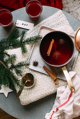 Non-alcoholic mulled wine with lemon and cinnamon in glass, flat lay