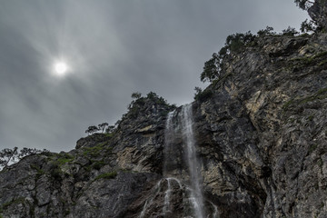 High waterfall with rocks around