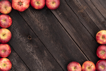 Brown wooden backround with red apples