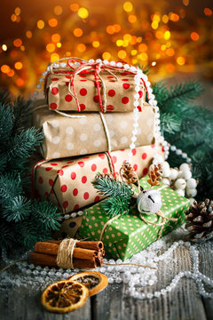 Merry Christmas and happy New year. Christmas gift and Christmas tree on dark wooden background. Selective focus.