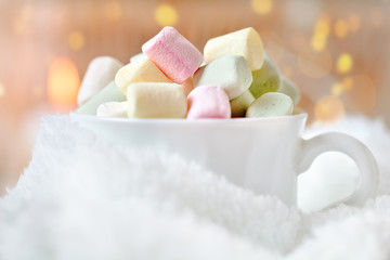 Merry Christmas and happy New year. Cup of cocoa and marshmallows on a light background. Background with copy space. Selective focus. Christmas background.