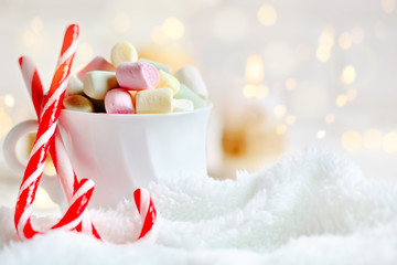 Merry Christmas and happy New year. Cup of cocoa and marshmallows on a light background. Background with copy space. Selective focus. Christmas background.