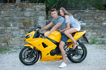 Plakat Young couple on a motor bike on a late summer afternoon