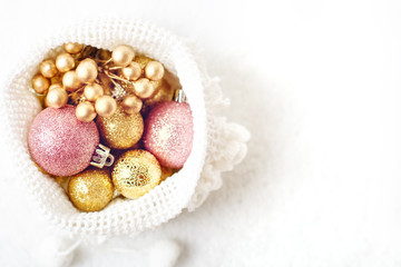 Merry Christmas and happy New year. Golden Christmas toys on a light background. Selective focus. Top view. Christmas background. Background with copy space.