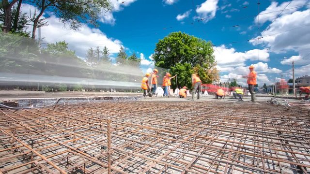 Concrete works for road construction with many workers and mixer timelapse hyperlapse