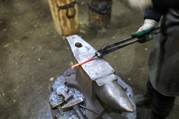 Blacksmith forges iron