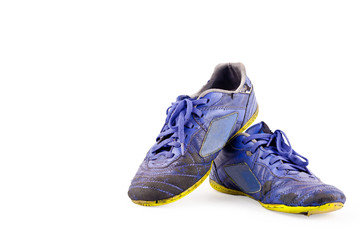 Old blue worn out futsal sports shoes on white background soccer sportware object isolated