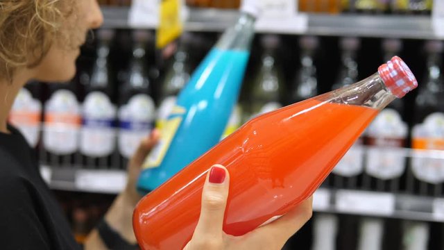 Customer Buying Colorful Soft Drink At Supermarket