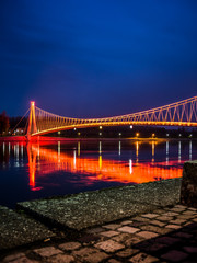 Side view of a colorful modern pedestrian bridge. Night in Osijek, Croatia.