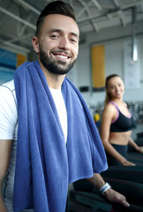 close up. an attractive man works in a modern gym