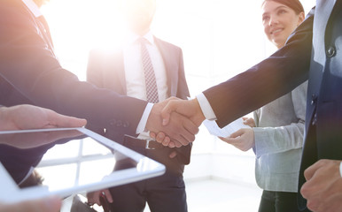 employees look at the handshake business partners