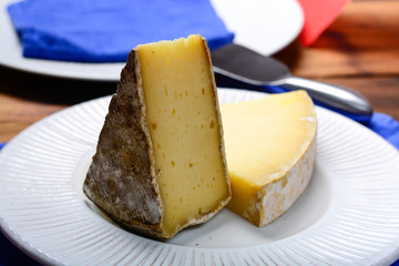 Pieces of French Tomme and Cantal cheese, close up
