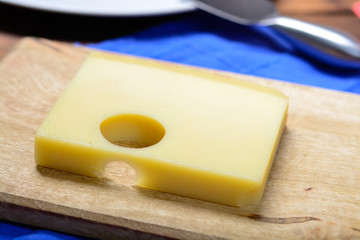 Swiss Emmental or Emmentaler medium-hard cheese with round holes made from cow milk in Canton Bern.
