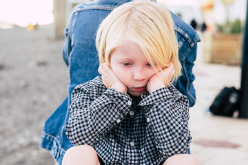 sad young kid lost in his thoughtful - blonde caucasian male child ungry - beautiful portrait...