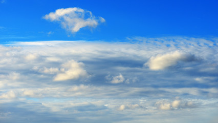 Naklejka na ściany i meble White clouds on the blue sky background