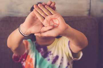 peace no war symbol painted on hand of young boy - message for the future generations - make love...