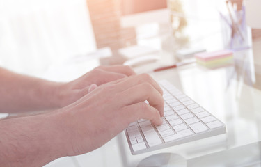 close-up of an employee typing on a personal computer keyboard.