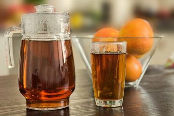 Pitcher and glass of hot black tea  background.