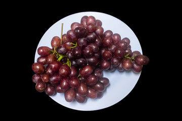 Healthy fruits, Ripe grapes in dish on black background 