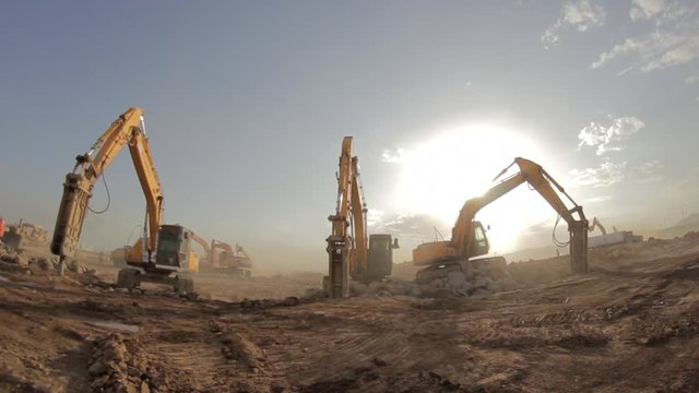 Hydraulic hammer breaker on excavator destroying rocks