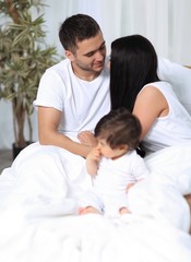 Fototapeta premium A happy young family from three persons