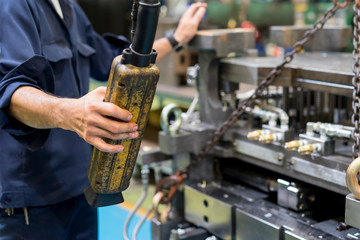 Worker moving high precision die mold for casting automotive aluminium parts with overhead crane in the factory