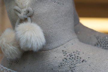 Fototapeta na wymiar Close-up: warm knitted women's shoes. Concept: stay comfortable & cozy at home with winter holiday gift.