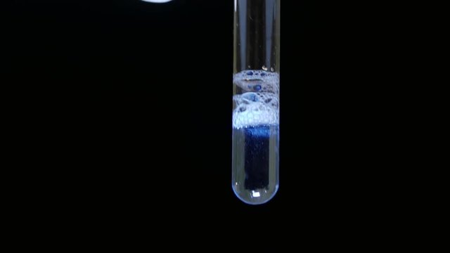 Scientist analyzing a chemical substance at the laboratory. Test tube close-up