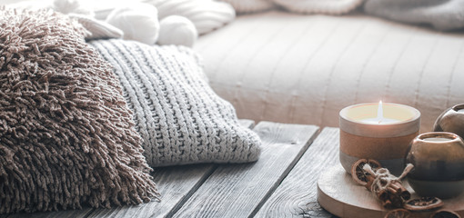 still life from home interior on a wooden background with a candle